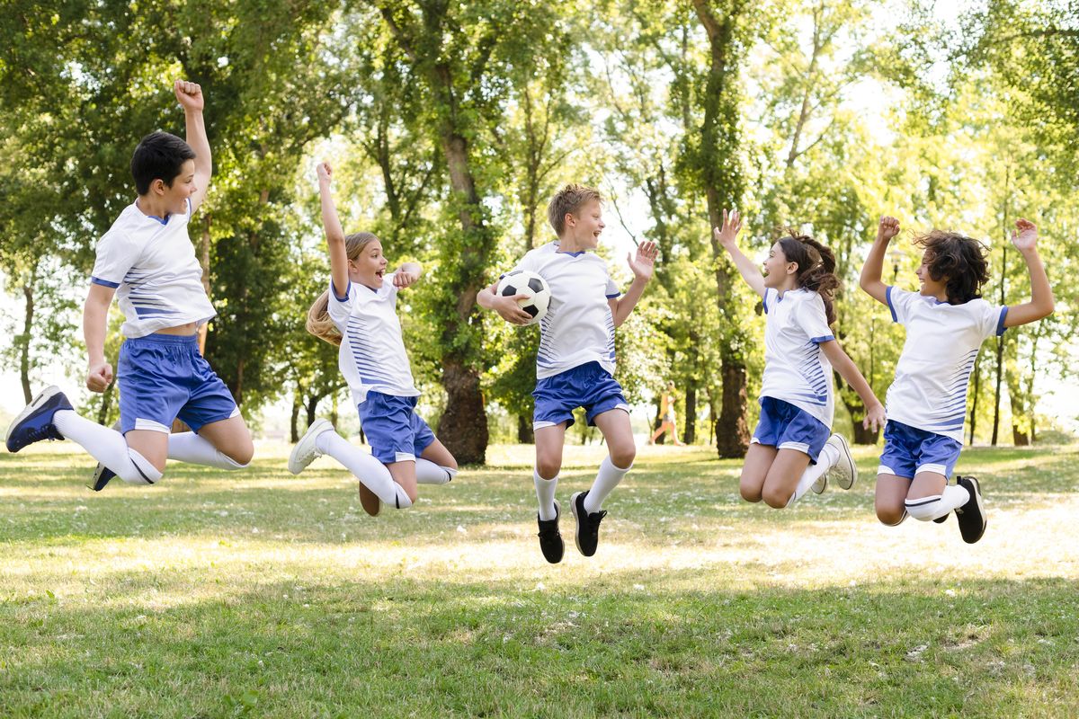 kids in sportswear jumping outdoors